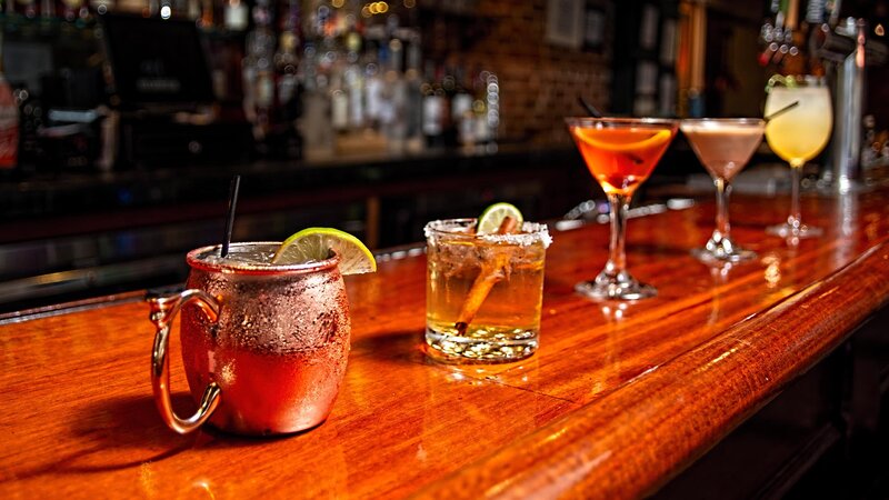 Line of different cocktails on the bar