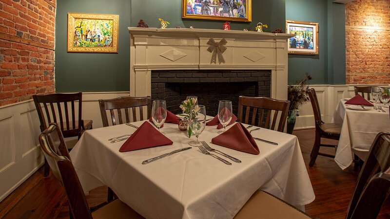 Table set for four and view of fireplace