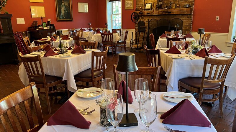 Dining room with fireplace and many set tables