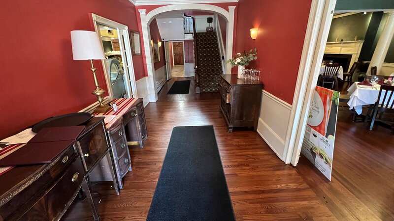 Entrance foyer with view of staircase and dining room