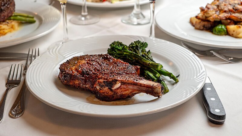 Bone-in steak entree with side of broccoli